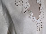 an image of a mannequin wearing a white dress with a lace collar