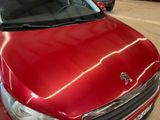 a red car that is parked in a parking lot