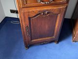 a wooden cabinet with a computer on top of it