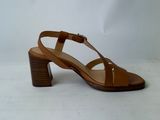 the heel of a woman ' s brown sandals on a white background