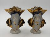 pair of blue and gold vases with fish heads on them