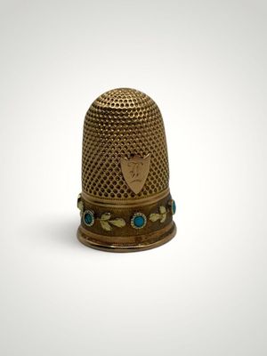 a close up of a thimble on a white surface