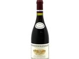 the bottle of wine is sitting on a white surface