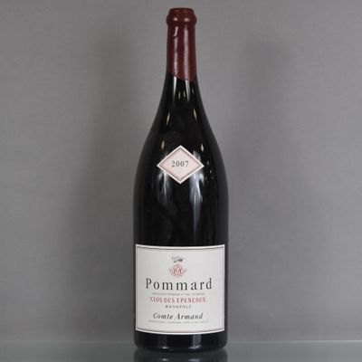 a bottle of wine that is sitting on a glass table