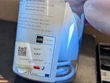 a person that is holding a small device in a box