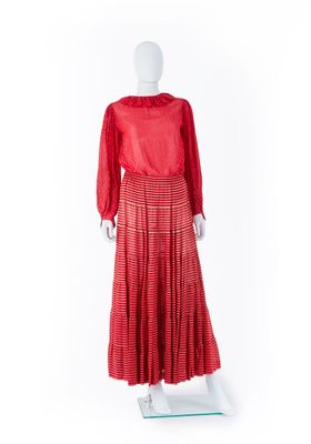 une robe rouge posée sur un présentoir à mannequin, sur fond blanc