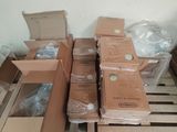 many boxes that are sitting on a pallet in the room