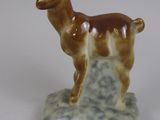 a figurine of a llama standing on a rock