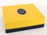 the box is yellow and black with a black lid