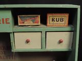 a small cabinet with two drawers and two boxes on it