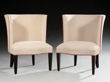 pair of upholstered chairs with red piping on the back