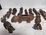 several wooden figurines of different shapes and sizes on a white surface