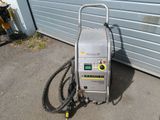 an image of a machine that is on the ground near a garage