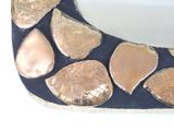 a picture of a gold and black shoe that is on a white surface