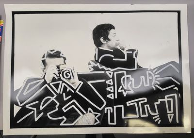 a black and white photo of a man and a woman sitting on a couch