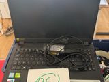 a laptop computer sitting on top of a wooden table