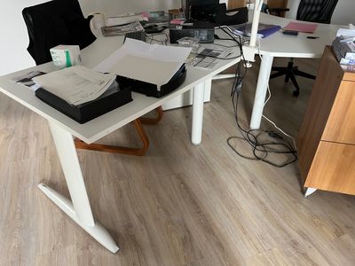 a desk with a laptop and a printer on it