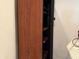 a cabinet in the middle of a room with a bike on the floor