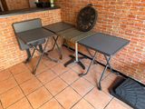 two tables and two chairs in a room