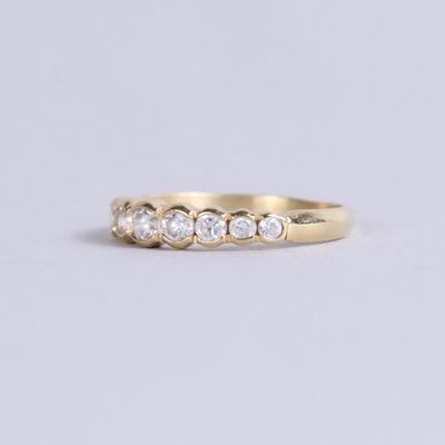 a yellow gold ring with three diamonds on the side