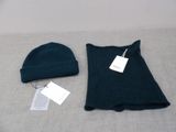 two hats and a sweater on a bed with a price tag