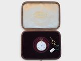 a small box with a pocket watch inside of it