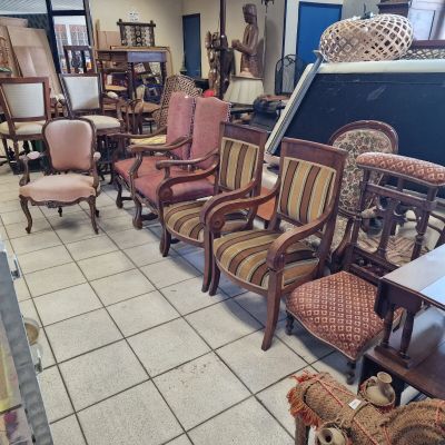 many chairs and tables in a room with a lot of furniture