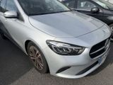 the mercedes cla is parked in a parking lot with other cars in the background