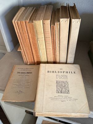 several books are stacked on top of each other on a table