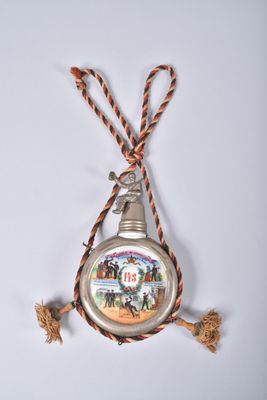 a silver pocket watch hanging from a rope