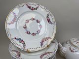 three plates and a bowl sitting on a table