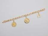 a close up of a gold chain bracelet with coins on it
