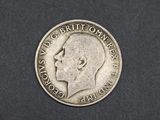 a close up of a silver coin on a black surface