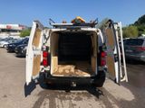 a white van with its doors open in a parking lot