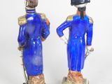 two figurines of a man and a woman dressed in blue
