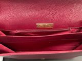 the inside of a red purse with a gold clasp