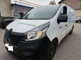 a white van parked in a parking lot next to a building