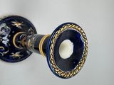 an image of a blue and gold candle holder on a wall