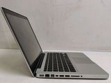 a laptop computer sitting on a table with a white wall in the background