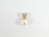 gros plan d'une bague en perles et diamants sur une surface blanche
