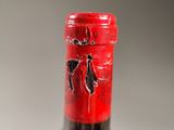 a bottle of wine that has a red label on it