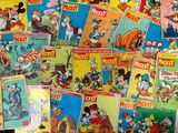 a lot of mickey mouse comics on the table