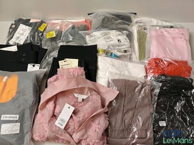 a lot of clothes that are sitting on a table