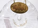 a glass bottle that has a gold medal on it