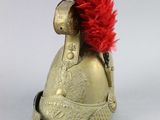 a gold helmet with a red feather on it