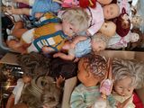 a lot of dolls in a box on the floor