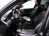 the interior of a car with black leather seats and a steering wheel