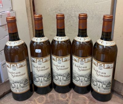 six bottles of wine are lined up on a counter