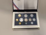 an image of a set of four coins in a box on a table
