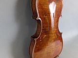 an old violin hanging on a wall with a white background